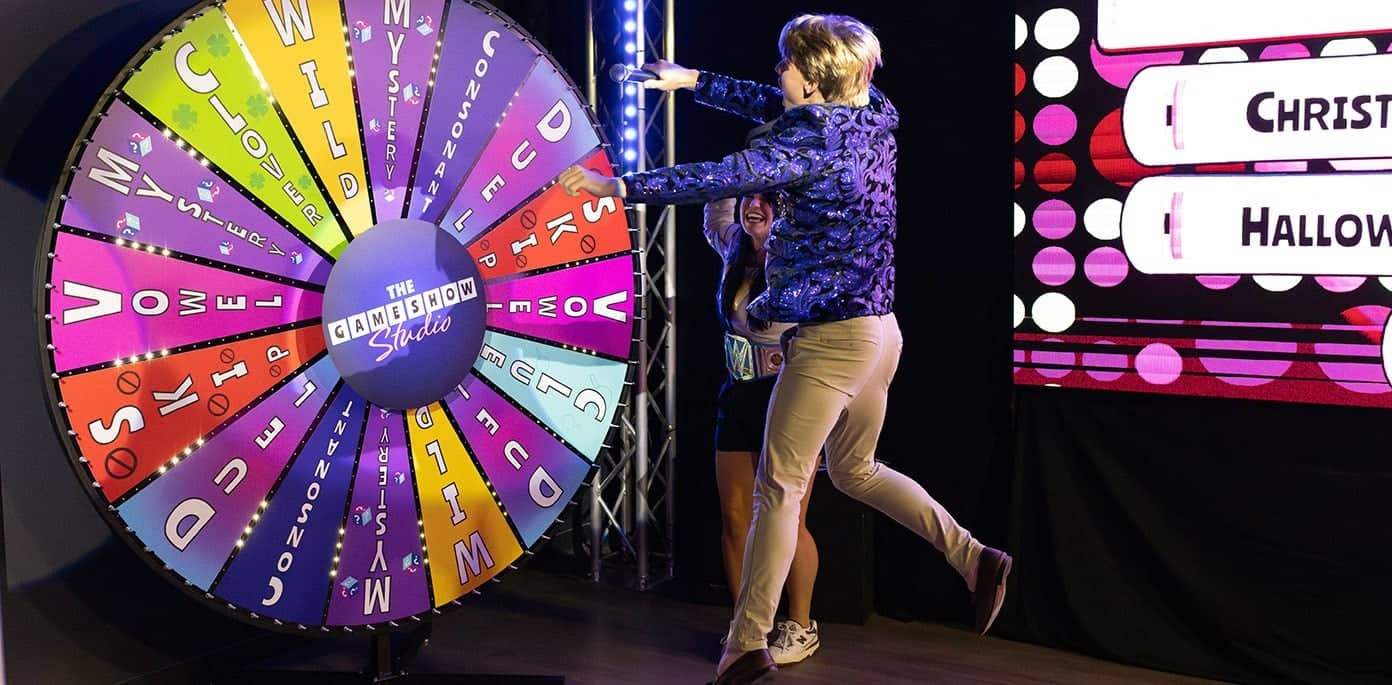 game show host jumping into the air