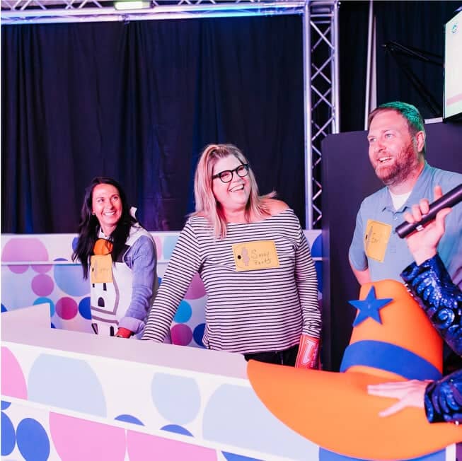 close-up of 3 contestants on game show studio