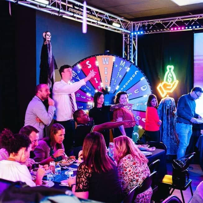 group of employees sitting around the fortune wheel