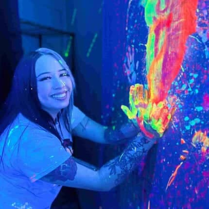 woman throwing paint on wall