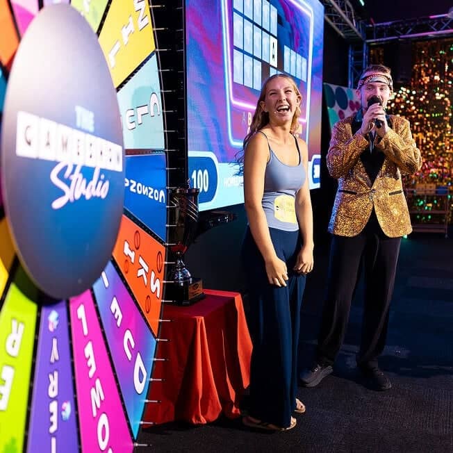 Game Show Studio host and contestant reviewing spin wheel