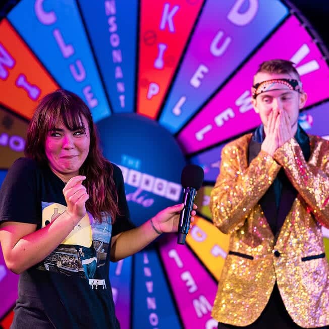 Game Show Studio contestant handing mic to host