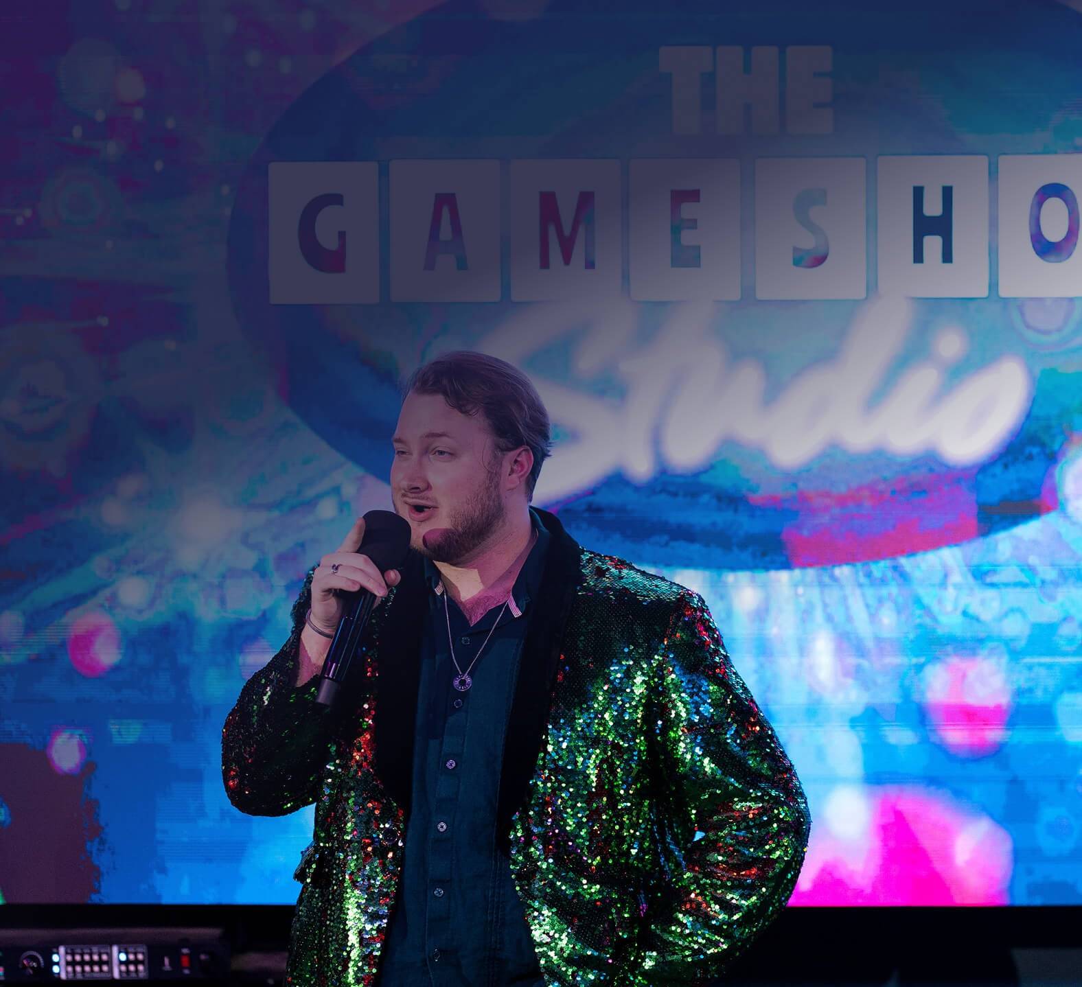 Game Show Studio host in sparkly jacket