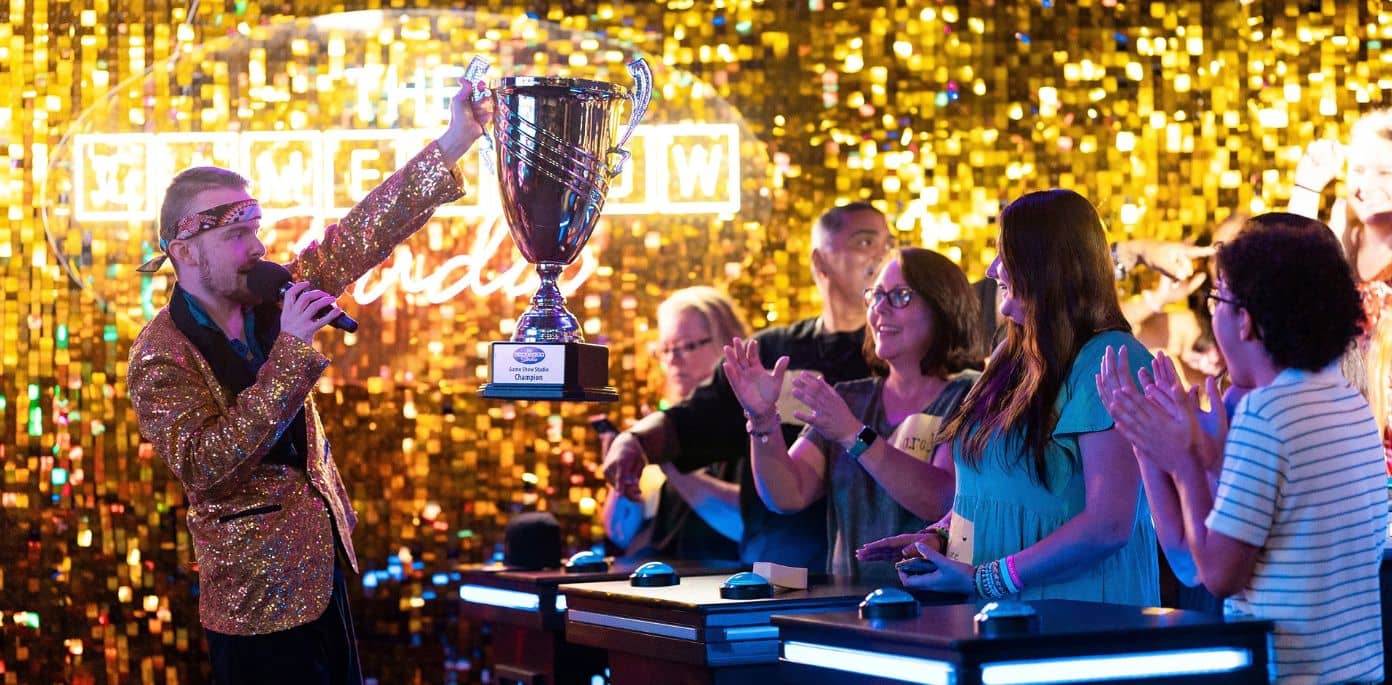 host holding big trophy