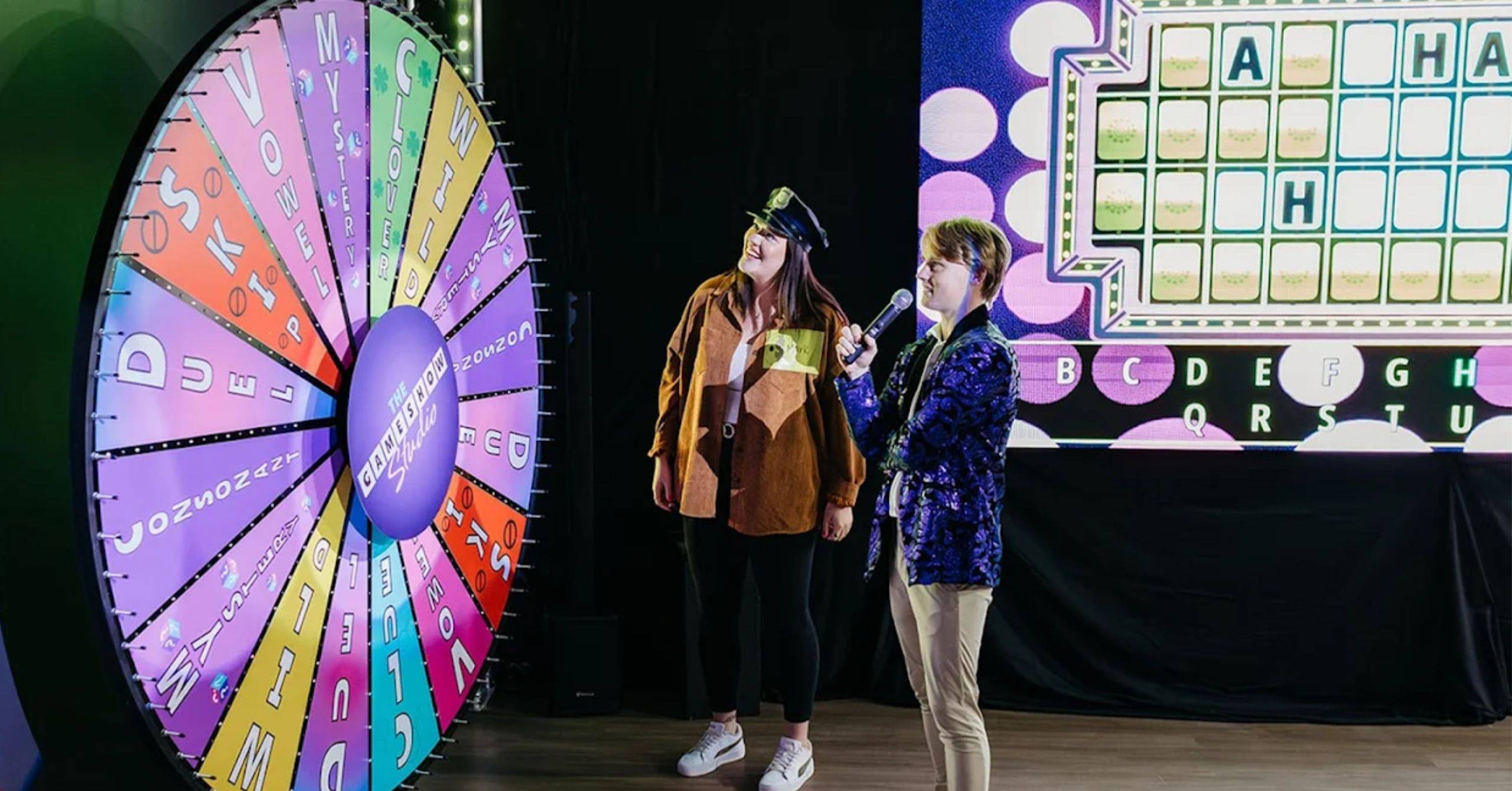 contestant standing in front of wheel