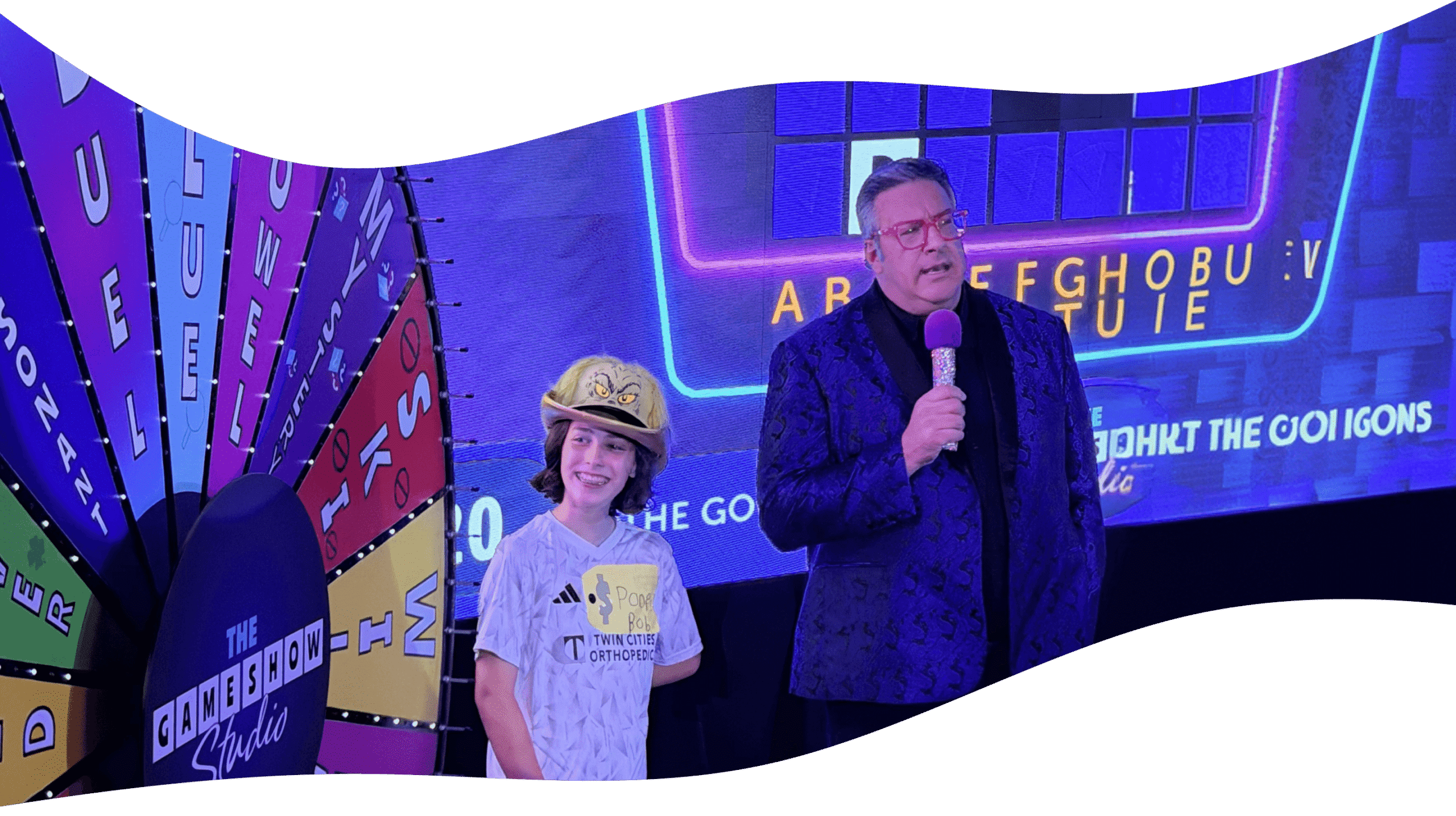 game show studio host asking kid contestant a question