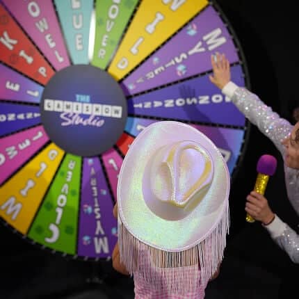 kid in front of game show studio wheel