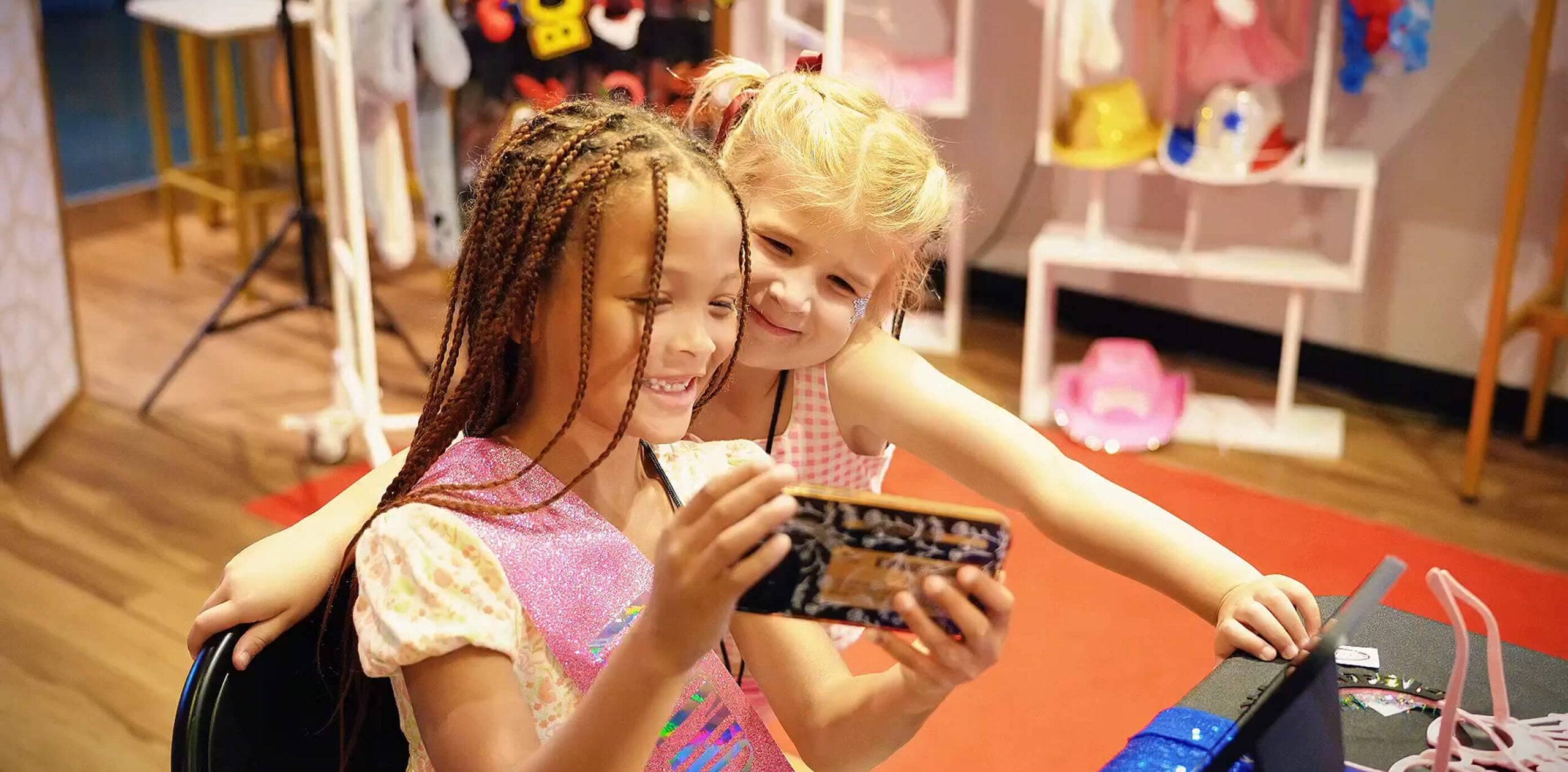 two kids looking at phone