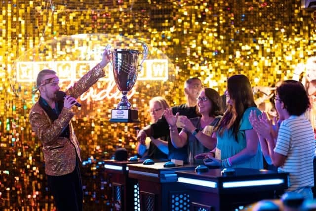 Host raising trophy for winning team at Game Show Studio