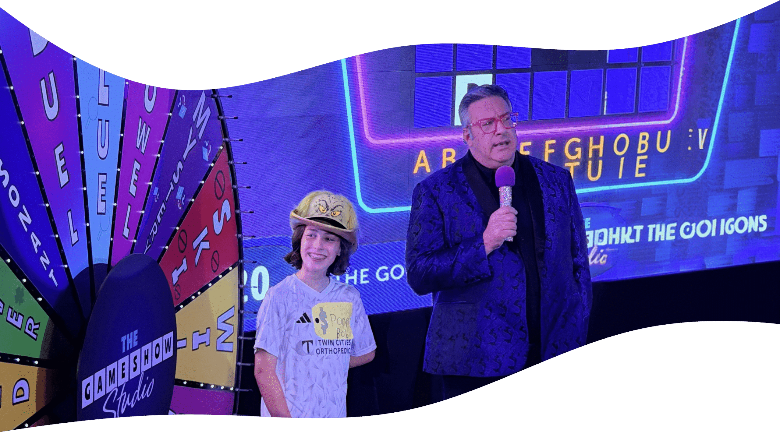 game show studio host asking kid contestant a question