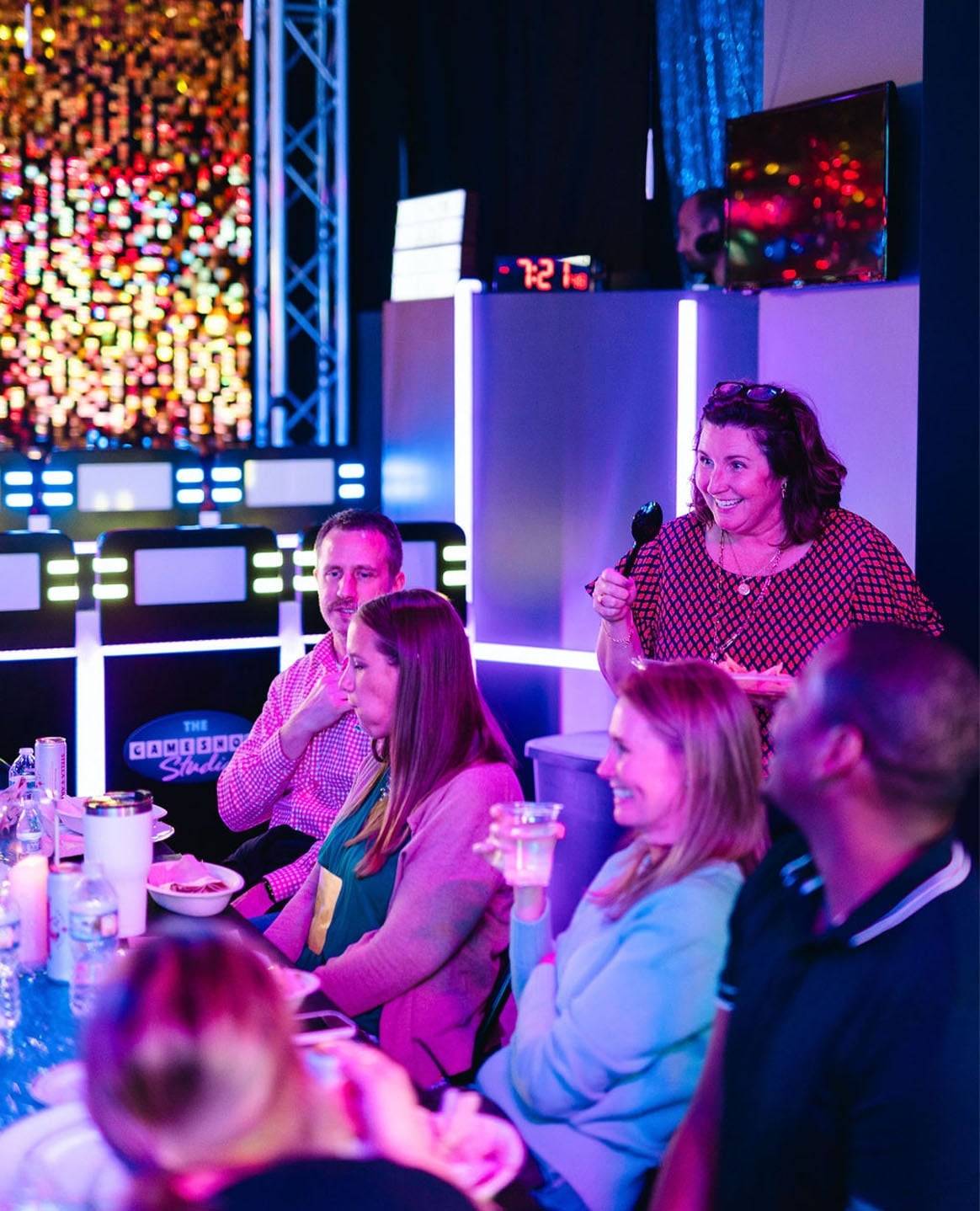 game show studio team deliberating on question