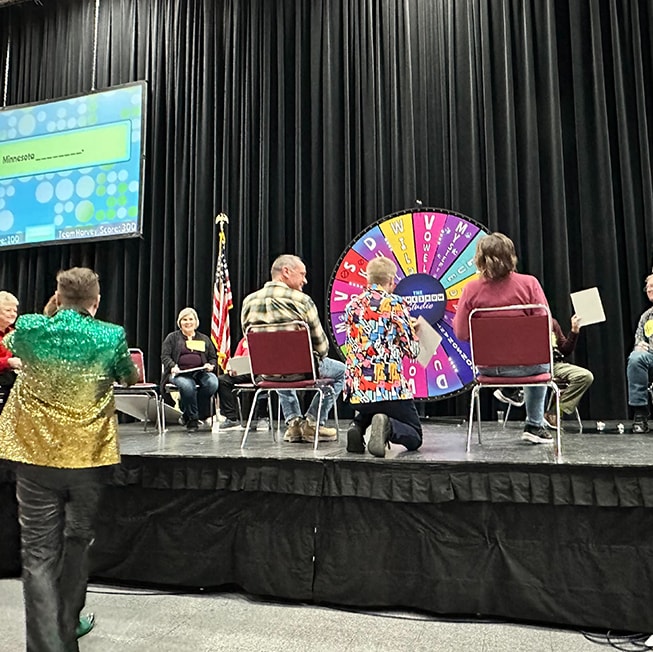 people sitting on stage playing a game